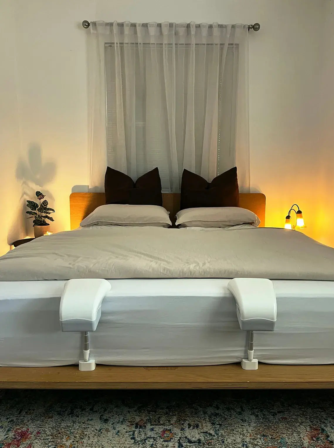 A queen bed with a grey duvet and two Fantail units at the foot.
